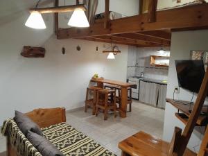 a living room with a couch and a table at Cabañas LaMaria in Coronel Suárez
