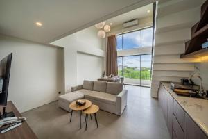 a living room with a couch and a table at Horizon Apartment with Ocean View in Cemagi