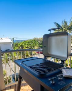 a grill sitting on a table on a balcony at Beach Days, Ocean Rooftop & Spa - Sleeps 8 in Marcoola