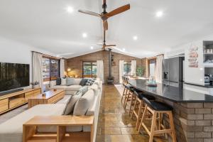 a kitchen and living room with a couch and a table at Glassy Waters in Sussex Inlet