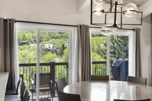 a dining room with a table and a large window at Woodbridge 29E in Snowmass Village