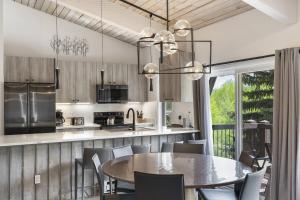 a kitchen and dining room with a table and chairs at Woodbridge 29E in Snowmass Village