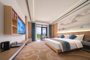 a hotel room with a large bed and a television at Shenzhoujie International Hotel-3min to Forest Park East Gate&Tickets reserve-Personal Itinerary service- Shuttle service in Zhangjiajie