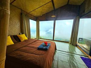 a bedroom with a bed with a red flower on it at Mon Ngo misty haven B3 in Ban Nong Chaeng +9 photos