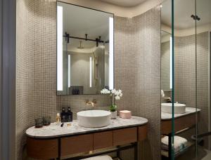 a bathroom with a sink and a mirror at Crystalbrook Kingsley in Newcastle +34 photos