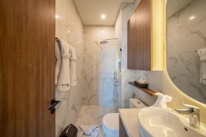 a bathroom with a shower and a sink and a toilet at Horizon Cemagi 2BR with Ocean View in Cemagi +58 photos