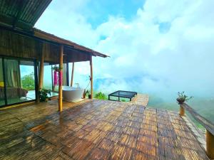 a deck with a bath tub on top of a house at Mon Ngo misty haven B3 in Ban Nong Chaeng