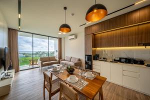 a kitchen and living room with a table and chairs at Horizon Cemagi 2BR with Ocean View in Cemagi
