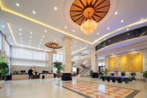 a lobby of a hotel with a checkered floor at Shenzhoujie International Hotel-3min to Forest Park East Gate&Tickets reserve-Personal Itinerary service- Shuttle service in Zhangjiajie