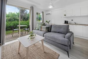 a living room with a couch and a table at Mackay Seabreeze Apartments in Mackay