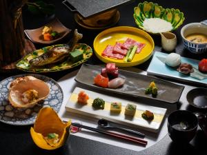 a table with many plates of food on it at Tsuta Onsen Ryokan in Towada +65 photos