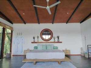 a bedroom with a bed and a ceiling fan at Cocolhu Treehouse & Ocean View in Tamarindo +21 photos