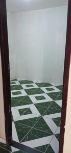 a room with a green and white tiled floor at Lazer do DUELÃO in Pão de Açúcar