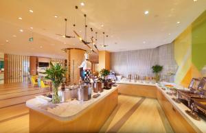 a restaurant with a counter in a room at Holiday Inn Express Shanghai Zhenping by IHG in Shanghai