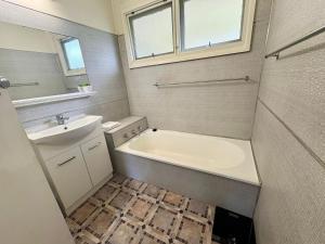 a bathroom with a bath tub and a sink at Horace Street 8 in Shoal Bay +7 photos