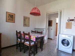 a dining room table with chairs and a washing machine at La Casina a Oleggio in Oleggio