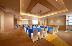 a conference room with blue tables and white chairs at Holiday Inn Express Shanghai Zhenping by IHG in Shanghai
