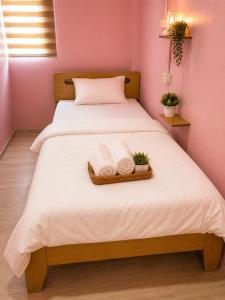 a bedroom with a bed with two towels on it at Hostel In The City in Pom Prap