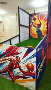 a basketball exhibit with a mural of a basketball player at Spago Inn-Only for Families & Couples not for Bachelors in Mahabalipuram