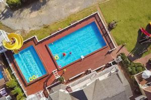 an overhead view of two large swimming pools at Taean Modern186 Pension in Taean +9 photos