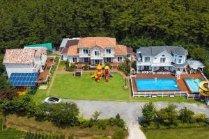 an aerial view of a house with a swimming pool at Taean Modern186 Pension in Taean