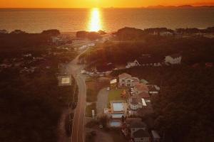 an aerial view of a city with the sun setting over the water at Taean Modern186 Pension in Taean