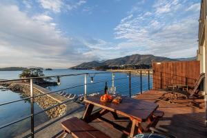 a table on a balcony with a view of the water at M129 Pension Namhae in Namhae