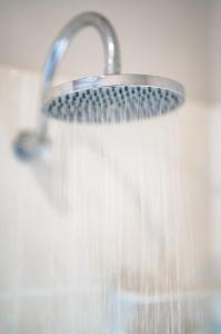 a shower with water coming out of it at Maleny Terrace Cottages in Maleny