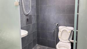 a bathroom with a toilet and a sink at Winnieys Boutique Hotel in Kuala Lumpur +14 photos