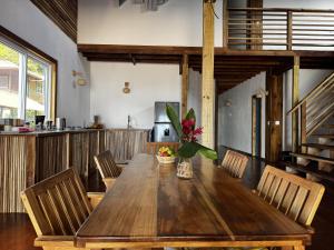a dining room with a wooden table and chairs at Blue Marlin in Bocas Town