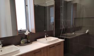 a bathroom with two sinks and a shower and a mirror at Adagio at Lonsdale in Point Lonsdale +11 photos