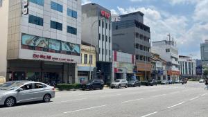 a city street with cars parked on the side of the road at Winnieys Boutique Hotel in Kuala Lumpur