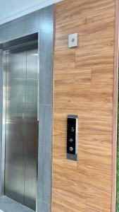 a metal elevator door with a sign on it at Winnieys Boutique Hotel in Kuala Lumpur