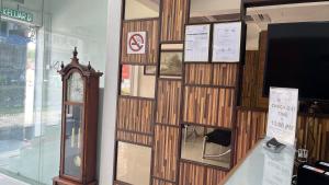 a wooden wall with a clock in a store at Winnieys Boutique Hotel in Kuala Lumpur