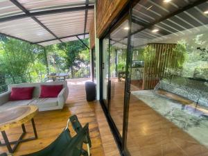 a living room with a white couch and a table at River View-Camping Add-On Available in Jarabacoa