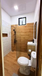 a bathroom with a toilet and a shower and a sink at River View-Camping Add-On Available in Jarabacoa