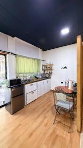 a large kitchen with a table and a tableablish at River View-Camping Add-On Available in Jarabacoa +57 photos