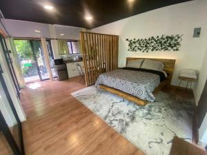 a bedroom with a bed in a room at River View-Camping Add-On Available in Jarabacoa
