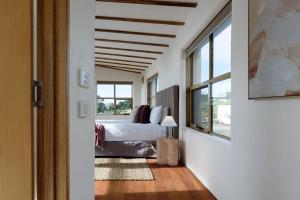 a bedroom with a bed and a window at The Hemp House | Table Cape Ocean Views in Table Cape