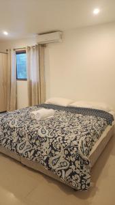 a bedroom with a bed with a blanket on it at Haven Retreat in Pacific Harbour