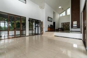 a large empty room with a lobby with glass doors at Barusen Hills By BHATARA in Gambung +46 photos