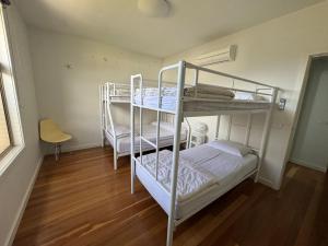 two bunk beds in a room with wooden floors at Amaroo by the beach in Queenscliff