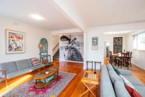 a living room with a couch and a table at Aurora in Queenscliff