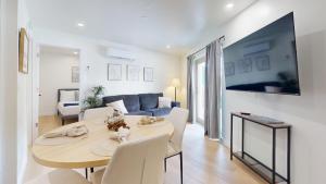 a living room with a table and a blue couch at Ocean's Edge Luxury Rentals in Ocean City