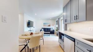 a kitchen and living room with a table and a dining room at Ocean's Edge Luxury Rentals in Ocean City