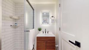 a bathroom with a sink and a shower at Ocean's Edge Luxury Rentals in Ocean City +67 photos