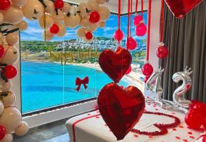 a room with a window with hearts and balloons at condostmaarten by the sea -Adults Only- in Koolbaai