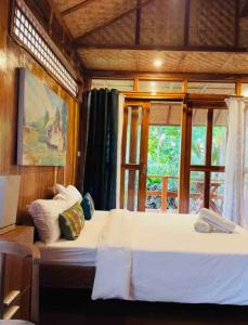 a large bed in a room with a window at Baha Bar in San Juan