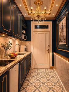 a kitchen with black cabinets and a chandelier at Salvo 1928 in Montevideo