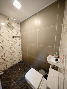 a bathroom with a toilet and a sink at Suíte cine centro in Garanhuns +9 photos